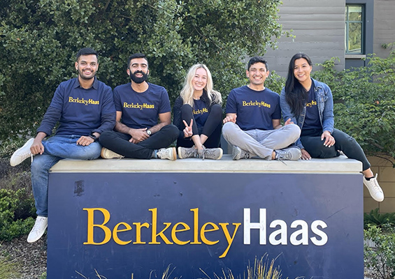 Rachel poses with classmates and friends atop the Berkeley Haas sign