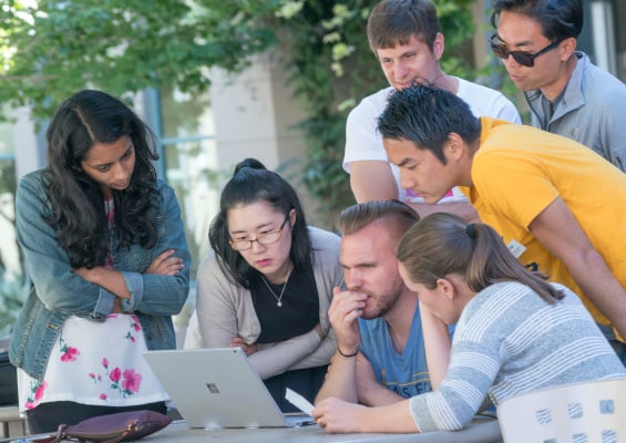 People working together in Berkeley Haas courtyard. 